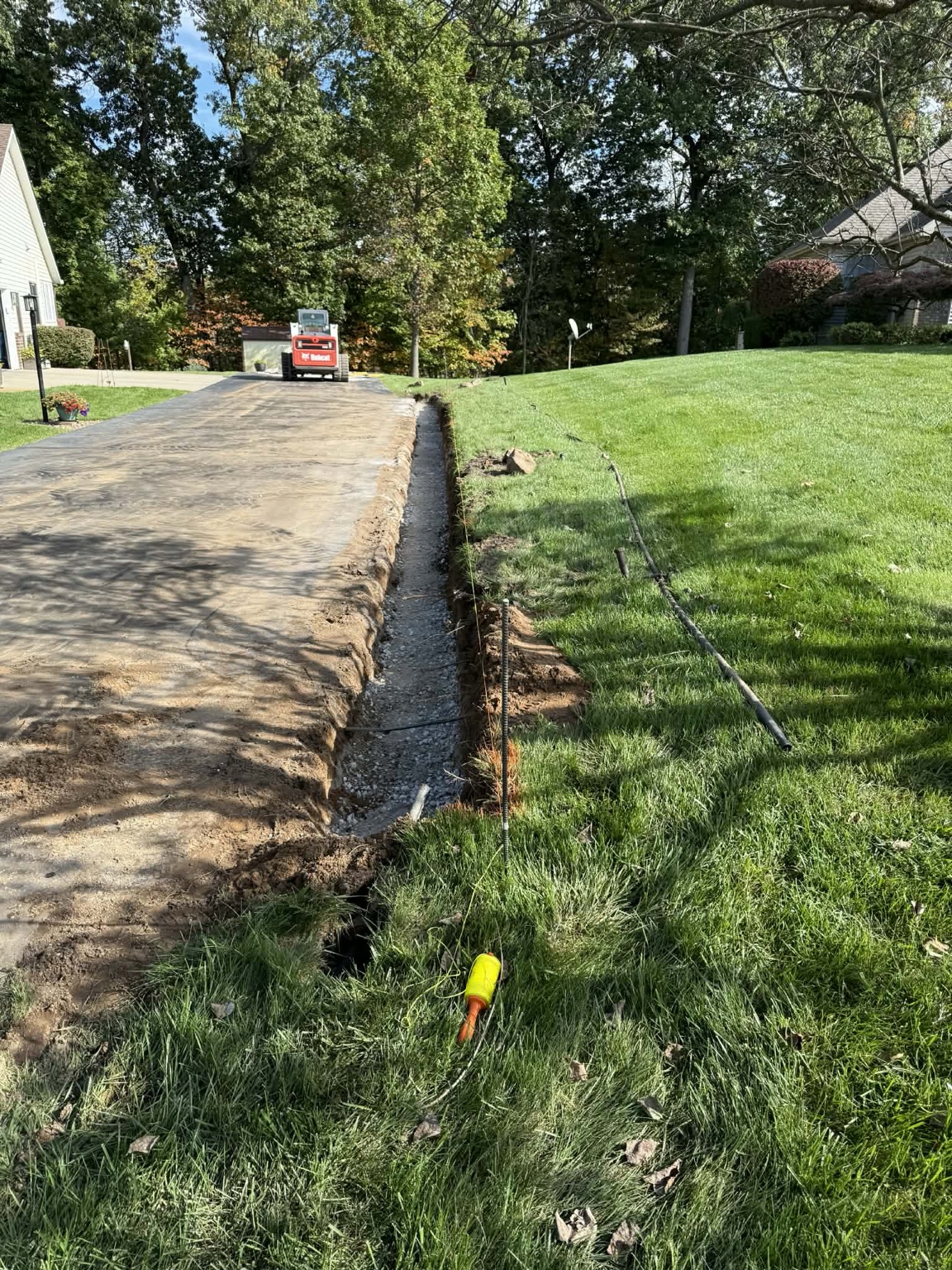 Compacted stone base being prepared for a retaining wall
