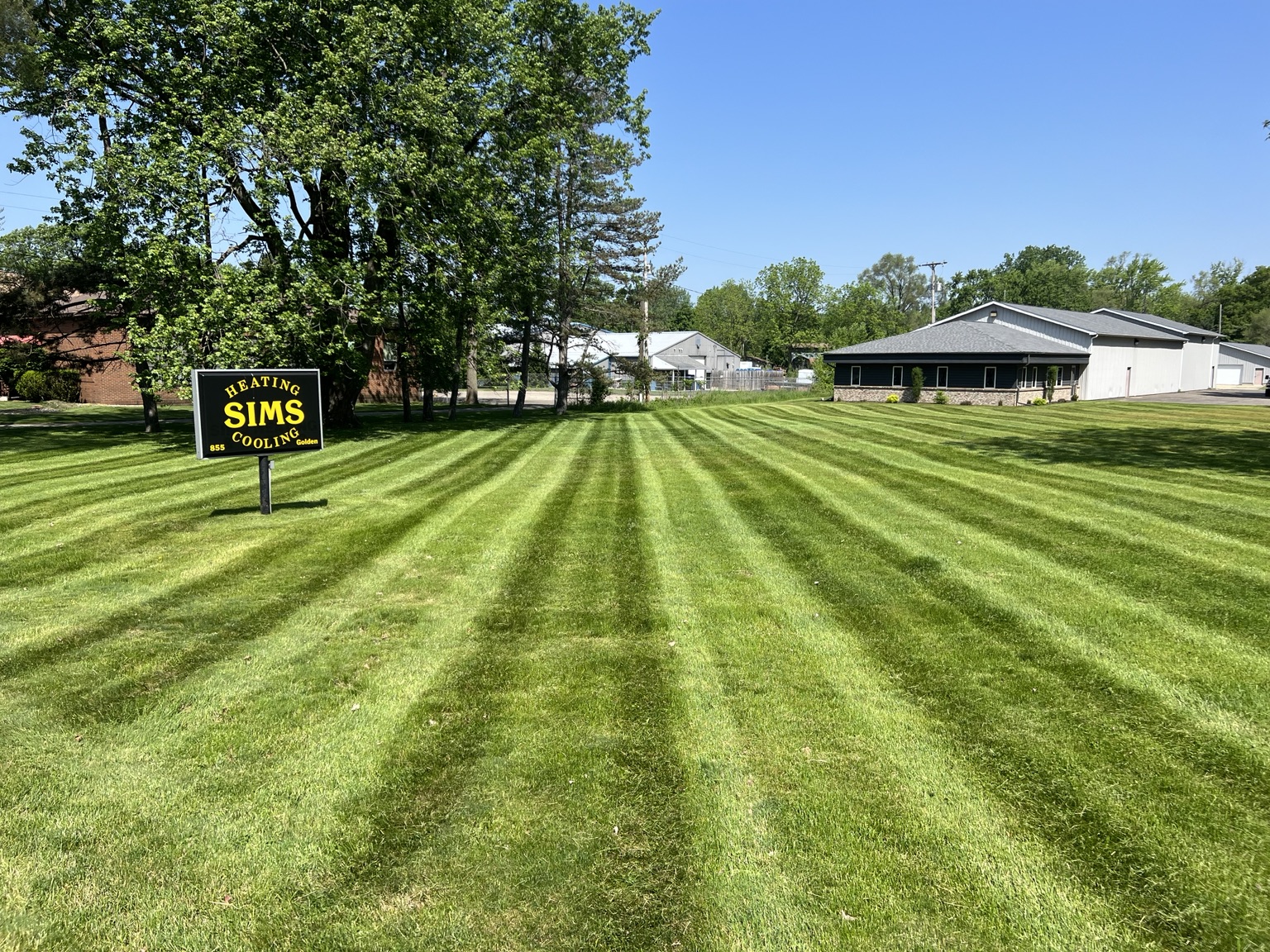 Freshly striped commercial lawn surrounding a business property