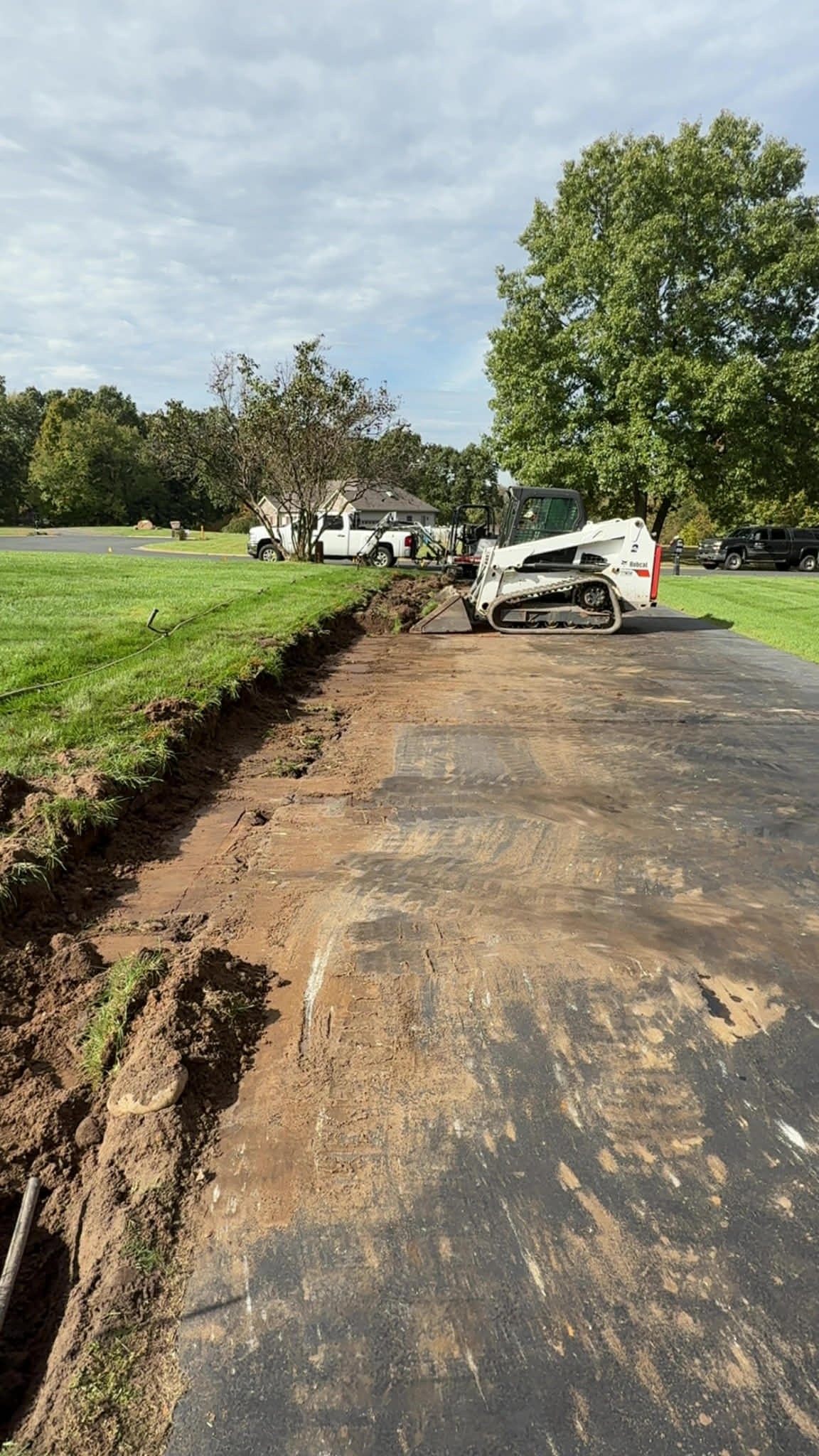 Bobcat excavating a residential retaining wall site